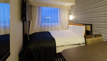 APA Hotel Shinjuku-Kabukicho Tower room interior. Gay-friendly hotel with bed, desk, & TV. Modern design, comfortable for gay travelers.