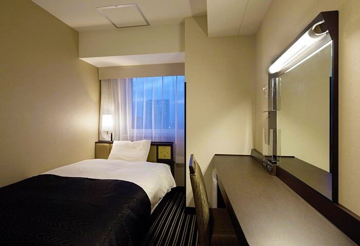 APA Hotel Shinjuku-Kabukicho Tower room. Single bed, desk with mirror, and chair. Gay-friendly hotel in Tokyo for gay men travel.