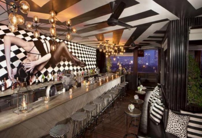 ARTOTEL Thamrin Jakarta's stylish bar. This gay-friendly hotel features a chic design, drinks, and a vibrant atmosphere.
