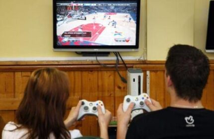 Guests playing video games at Abbey Court Hostel, a gay-friendly hotel. Enjoy gaming during your stay. #GayTravel #HostelLife