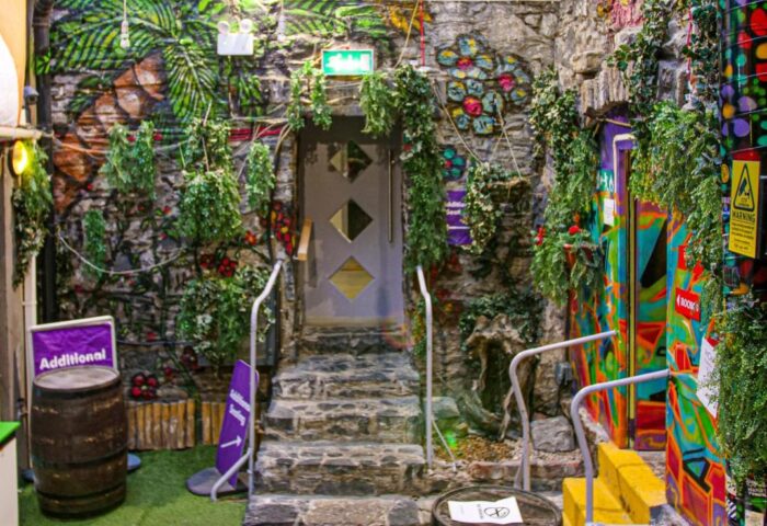 Abbey Court Hostel's unique interior. Stone walls, murals, and greenery create a vibrant, welcoming space. Great gay-friendly hotel choice.