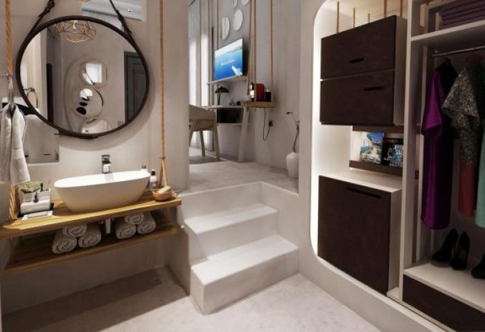 Absolute Mykonos Suites gay-friendly hotel room. Modern bathroom with sink, mirror, and closet. Stylish interior design for gay travelers.