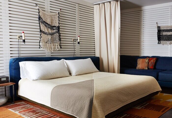 Ace Hotel and Swim Club Palm Springs room. Gay-friendly hotel room with bed, couch, and unique decor. A great hotel for gay men travelers.