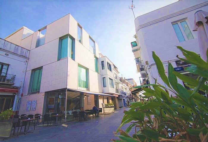 Alenti Sitges Hotel & Restaurant exterior view. Gay-friendly hotel in Sitges, Spain. Street view of the hotel and restaurant, perfect for gay travel.
