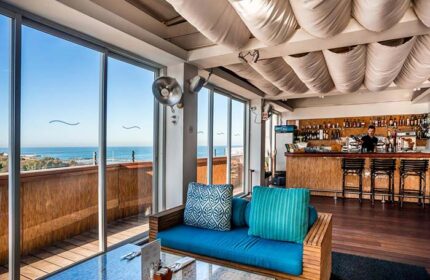Alexander Tel Aviv Hotel's gay-friendly bar. Ocean view from the lounge area with blue sofa. A great place for gay travelers.