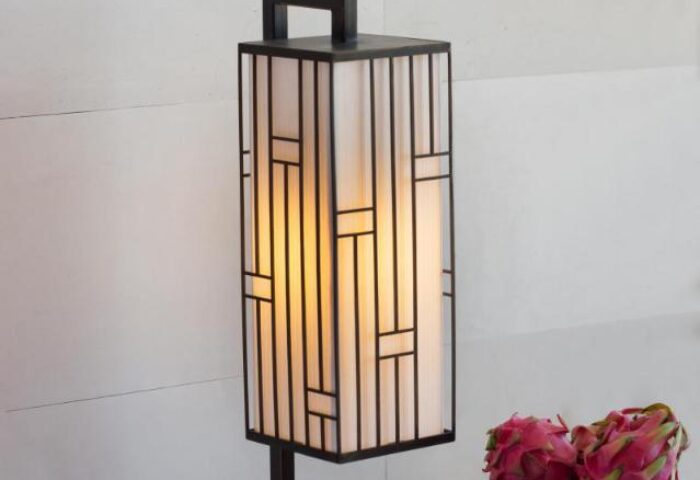Stylish lamp at Alila Seminyak, a gay-friendly hotel. The lamp has a geometric design and soft lighting, creating a relaxing ambiance.