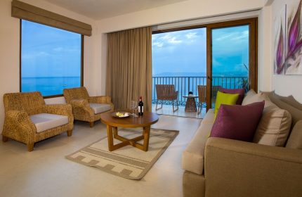 Almar Resort Luxury LGBT Beach Front Experience suite. Ocean view from balcony, seating area with sofa, chairs, and table. Gay-friendly hotel.