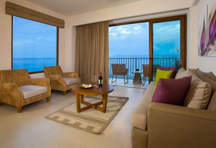 Almar Resort Luxury LGBT Beach Front Experience suite. Ocean view from balcony, seating area with sofa, chairs, and table. Gay-friendly hotel.