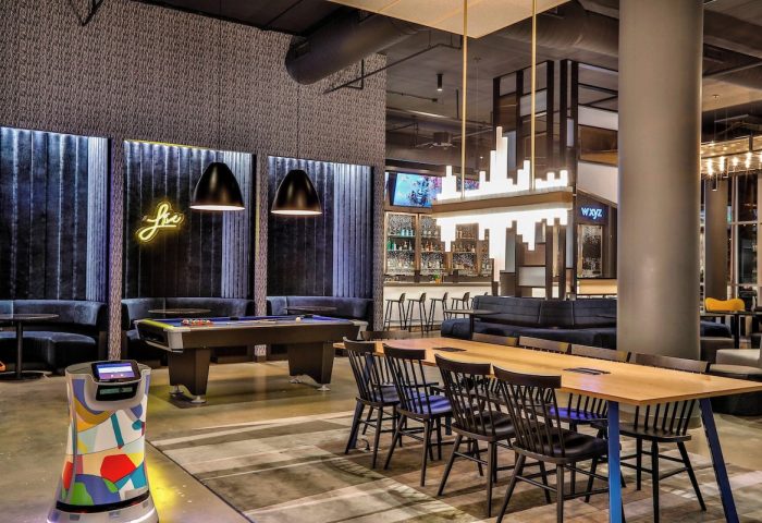 Aloft Chicago Mag Mile gay-friendly hotel interior. Lounge and bar area with pool table, tables, and seating. Modern design. Cool and inviting.