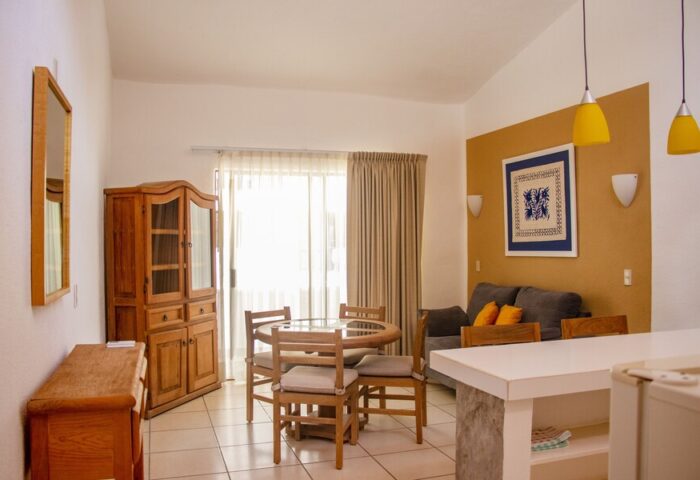 Amapas Apartments Puerto Vallarta living space. Gay-friendly hotel featuring dining table, sofa, and kitchen area. Comfortable stay in PV.