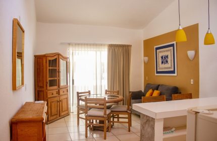 Amapas Apartments Puerto Vallarta living space. Gay-friendly hotel featuring dining table, sofa, and kitchen area. Comfortable stay in PV.