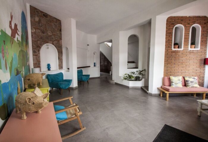 Lobby at Gay-Friendly Amapas Apartments, Puerto Vallarta. Interior design with colorful mural, brick accents, and unique decor for gay travelers.