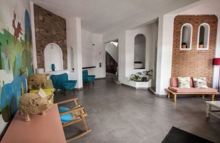 Lobby at Gay-Friendly Amapas Apartments, Puerto Vallarta. Interior design with colorful mural, brick accents, and unique decor for gay travelers.