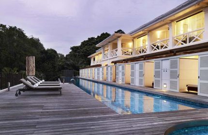 Amara Sanctuary Resort Sentosa pool view. Gay-friendly hotel with SG Clean certification. Deck chairs by the pool. Ideal for gay travel.