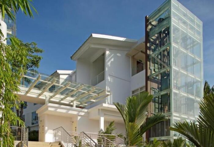 Amara Sanctuary Resort Sentosa exterior. Gay-friendly hotel with glass elevator, SG Clean Certified. Modern architecture, lush greenery.
