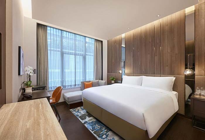 Amara Singapore gay-friendly hotel room. Modern design, king bed, desk, and city view. Ideal for gay travelers seeking comfort & style.