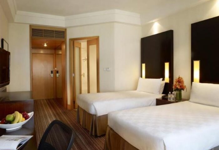 Amara Singapore hotel room. Twin beds in a gay-friendly hotel. Modern design with fruit bowl. Perfect for gay travel in Singapore.