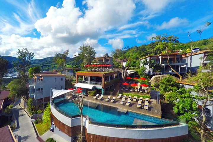 Amari Phuket gay-friendly hotel aerial view. Pool, red umbrellas, and SHA certified. Thailand resort for gay men travel.