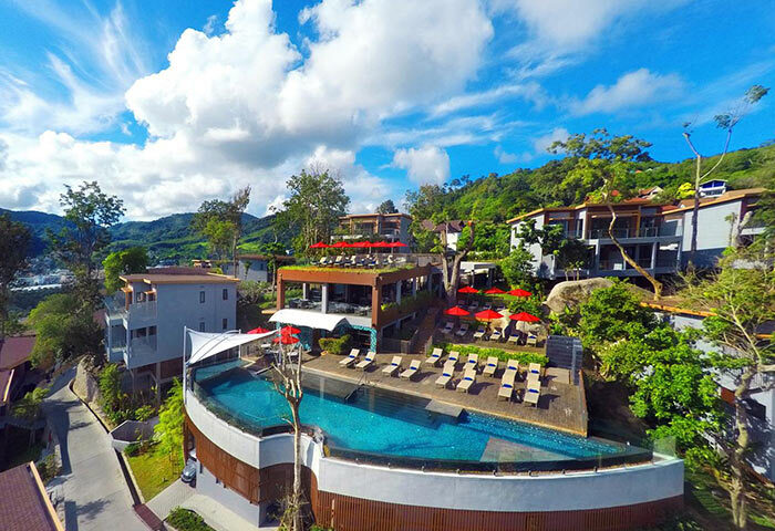 Amari Phuket gay-friendly hotel aerial view. Pool, red umbrellas, and SHA certified. Thailand resort for gay men travel.