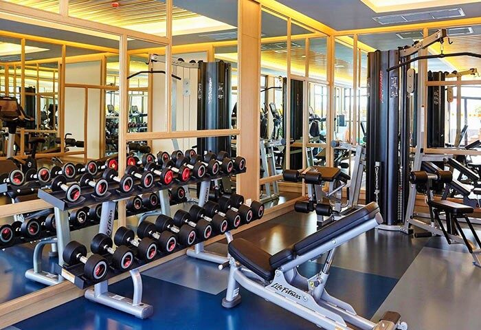 Amari Phuket SHA-certified hotel gym. Dumbbells, weight machines, and mirrors. Gay-friendly hotel in Thailand for men's travel advice.