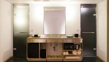 Amba Taipei Ximending hotel bathroom. Modern design with sink, mirror, shower doors, and amenities. Gay-friendly hotel in Taipei, Taiwan.