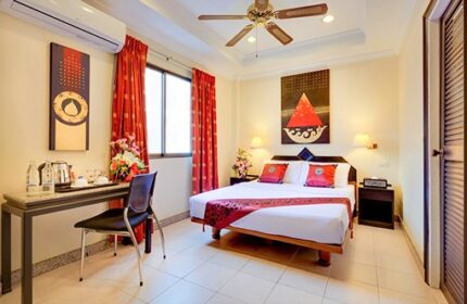 Ambiance Pattaya Hotel gay-friendly room. Clean, well-lit space with a bed, desk, and red accents. A comfortable stay for gay travelers.