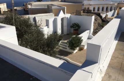 Amelot Art Suites: View of a gay-friendly hotel's white-washed courtyard with plants and steps. A tranquil, stylish space for gay travelers.