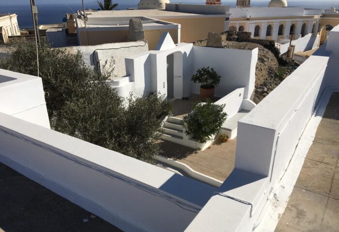 Amelot Art Suites: View of a gay-friendly hotel's white-washed courtyard with plants and steps. A tranquil, stylish space for gay travelers.