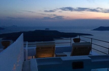 Amelot Art Suites gay-friendly hotel view. Jacuzzi and deck chairs overlook the sea at dusk. Ideal gay travel destination.