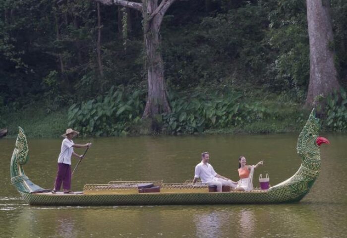 Gay-friendly Anantara Angkor Resort: Couple on a boat tour. The luxury hotel offers unique experiences in Siem Reap, Cambodia.
