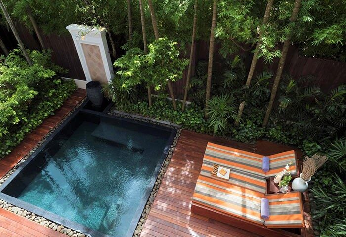 Private pool and lounge chairs at gay-friendly Anantara Angkor Resort. Lush greenery surrounds this relaxing oasis in Siem Reap.