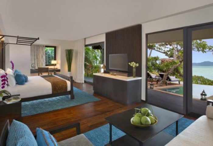 Anantara Bophut Koh Samui Resort gay-friendly hotel room. Bedroom, living area, and ocean view. Luxurious travel for gay men.