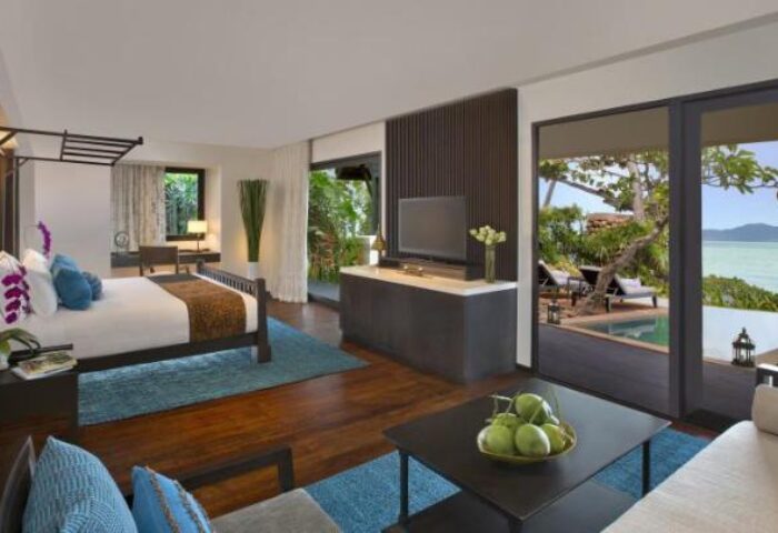 Anantara Bophut Koh Samui Resort gay-friendly hotel room. Bedroom, living area, and ocean view. Luxurious travel for gay men.