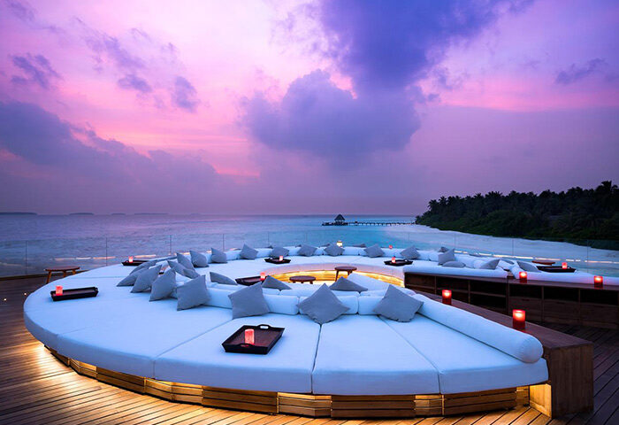 Gay-Friendly Hotel Anantara Kihavah Maldives Villas lounge area at sunset. Luxury travel for gay men in the Maldives. Romantic getaway.