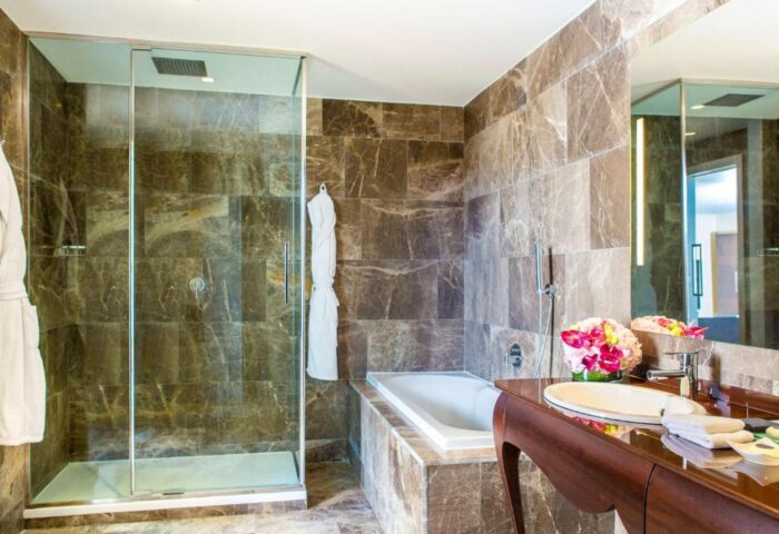 Anantara New York Palace Budapest bathroom. Gay-friendly, pet-friendly hotel with shower, tub, and marble decor. Luxury gay travel.