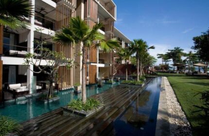 Anantara Seminyak Bali Resort exterior view. Gay-friendly hotel with pool, palm trees, and modern architecture. Bali travel destination.