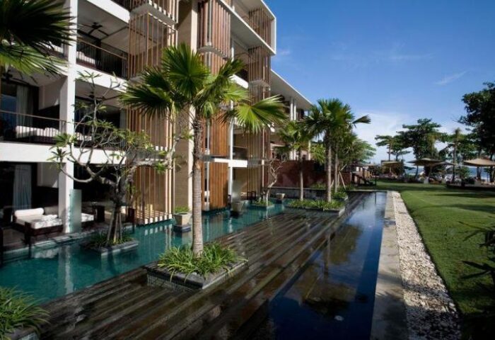 Anantara Seminyak Bali Resort exterior view. Gay-friendly hotel with pool, palm trees, and modern architecture. Bali travel destination.