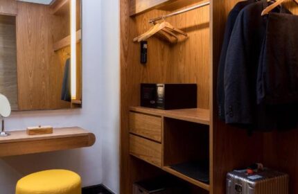 Closet details at Anantara Seminyak Bali Resort, a gay-friendly hotel. Features include a safe, suit, and mirror. Ideal for gay men's travel.