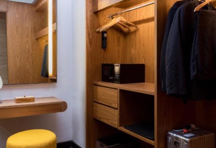 Closet details at Anantara Seminyak Bali Resort, a gay-friendly hotel. Features include a safe, suit, and mirror. Ideal for gay men's travel.