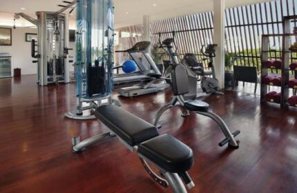 Anantara Seminyak Bali Resort's gym. A gay-friendly hotel with modern fitness equipment, treadmills, and weights for a healthy vacation.