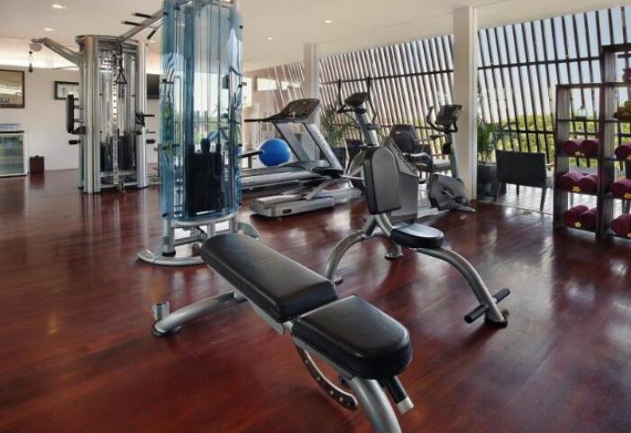 Anantara Seminyak Bali Resort's gym. A gay-friendly hotel with modern fitness equipment, treadmills, and weights for a healthy vacation.
