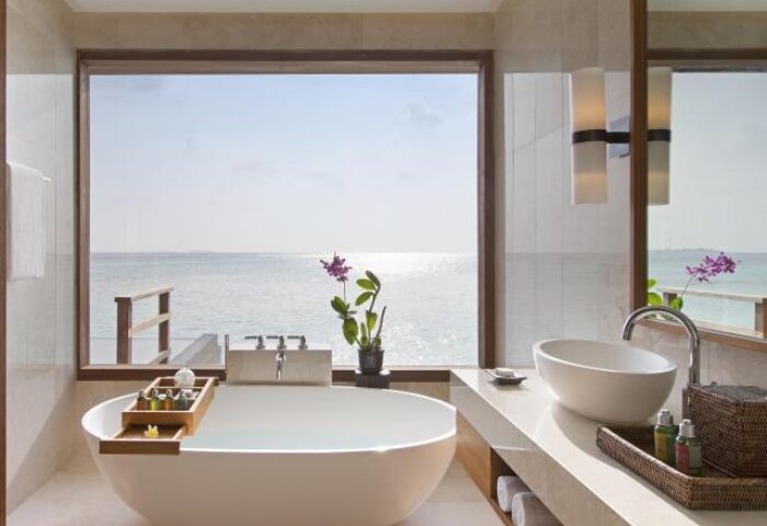 Bathroom with ocean view at Gay-Friendly Anantara Veli Maldives Resort. Luxury gay travel in the Maldives. Overwater bungalow bathroom.