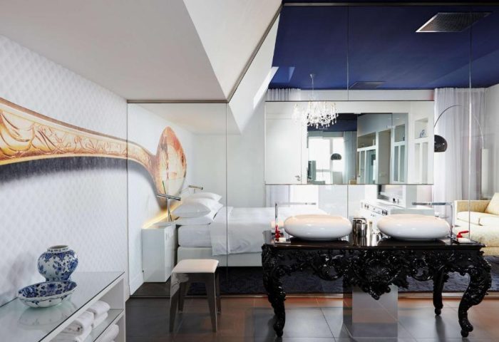 Andaz Amsterdam Prinsengracht gay-friendly hotel room. Modern design with spoon art, twin sinks, & blue ceiling. Luxury stay in Amsterdam.
