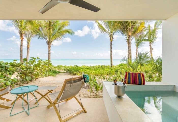 Andaz Mayakoba Resort Riviera Maya, a gay-friendly hotel by Hyatt. Ocean view from a suite's patio with chairs, plunge pool, and chilled drinks.