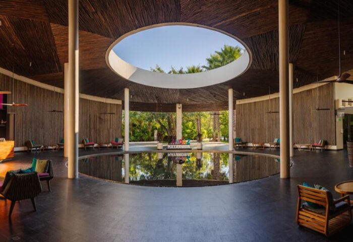 Andaz Mayakoba Resort Riviera Maya lobby. Gay-friendly hotel interior with circular pool, open-air design. Hyatt luxury travel.