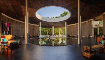 Andaz Mayakoba Resort Riviera Maya lobby. Gay-friendly hotel interior with circular pool, open-air design. Hyatt luxury travel.