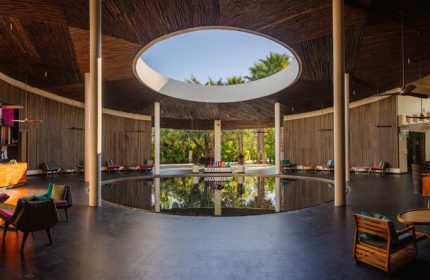 Andaz Mayakoba Resort Riviera Maya lobby. Gay-friendly hotel interior with circular pool, open-air design. Hyatt luxury travel.