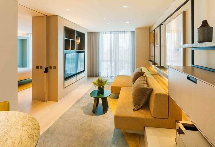 Andaz Seoul Gangnam gay-friendly hotel room. Modern interior with sofa, TV, and stylish decor. A comfortable stay in Seoul's vibrant district.