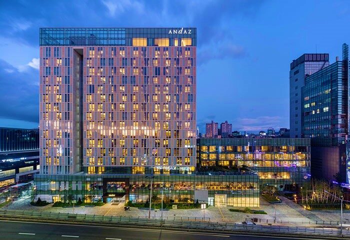 Andaz Seoul Gangnam exterior at dusk. Gay-friendly hotel with modern architecture. A great choice for gay men traveling to Seoul, South Korea.