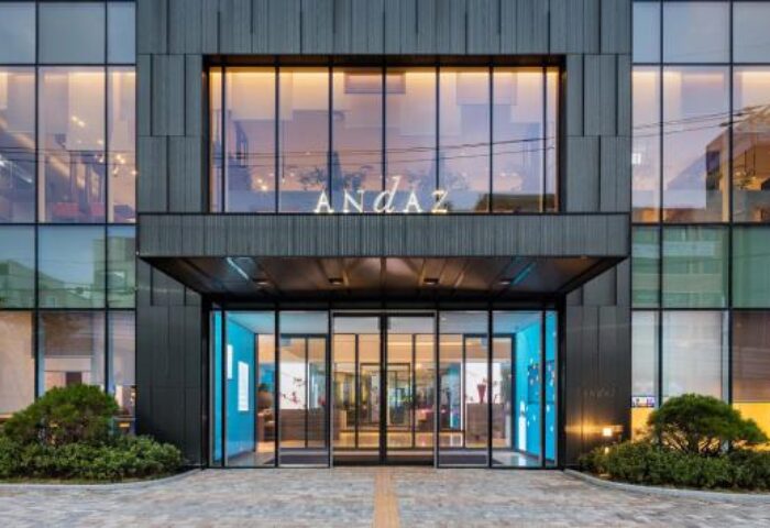Andaz Seoul Gangnam's facade. This gay-friendly hotel in Seoul features a modern glass and steel design, promising a luxurious stay.